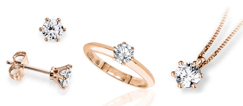 Parure en or rose et diamant composée de boucles d'oreilles, d'une bague et d'un pendentif avec serti six griffes